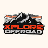 Stack of custom off-road logo stickers in black orange and silver